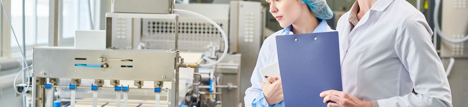 Control specialists of food plant analyzing work of conveyor