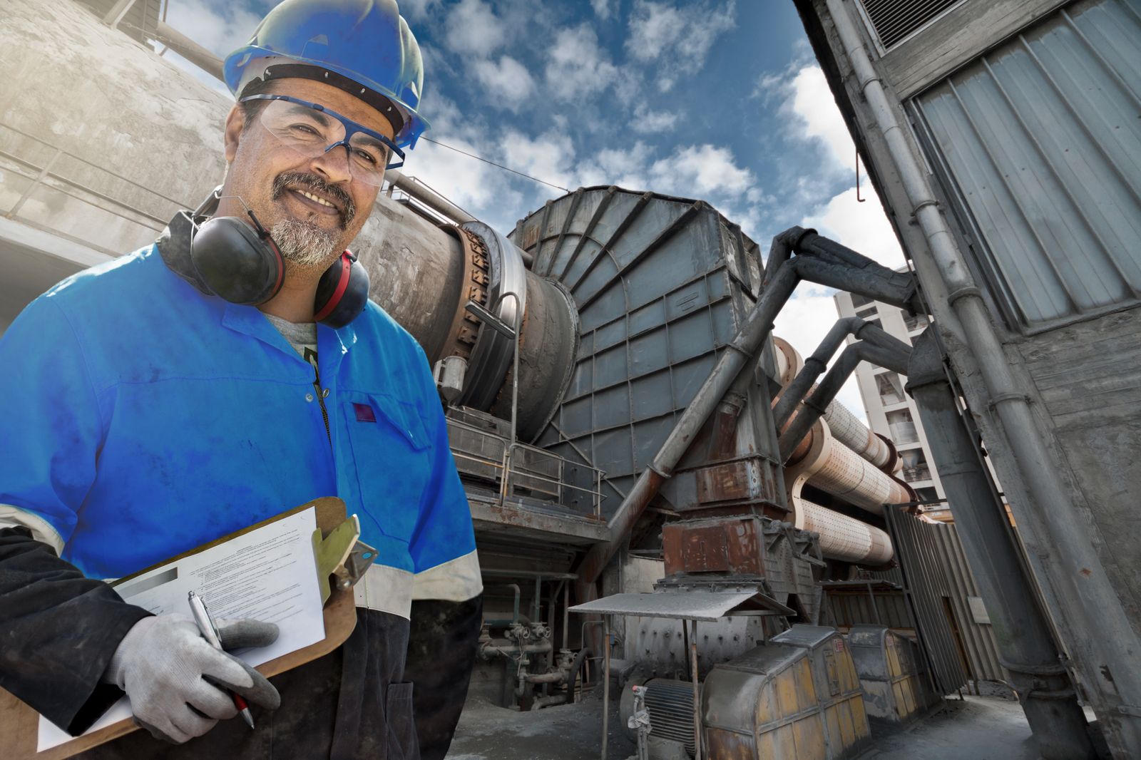 Friendly man in front of a cement plant 