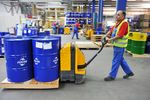 FUCHS worker with FUCHS drums in warehouse