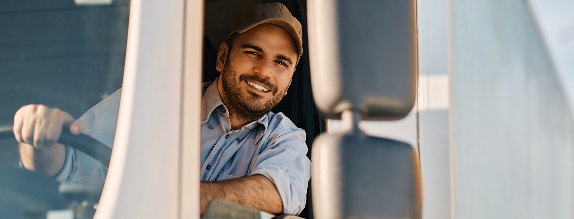 Happy,Professional,Truck,Driver,Driving,His,Truck,And,Looking,At