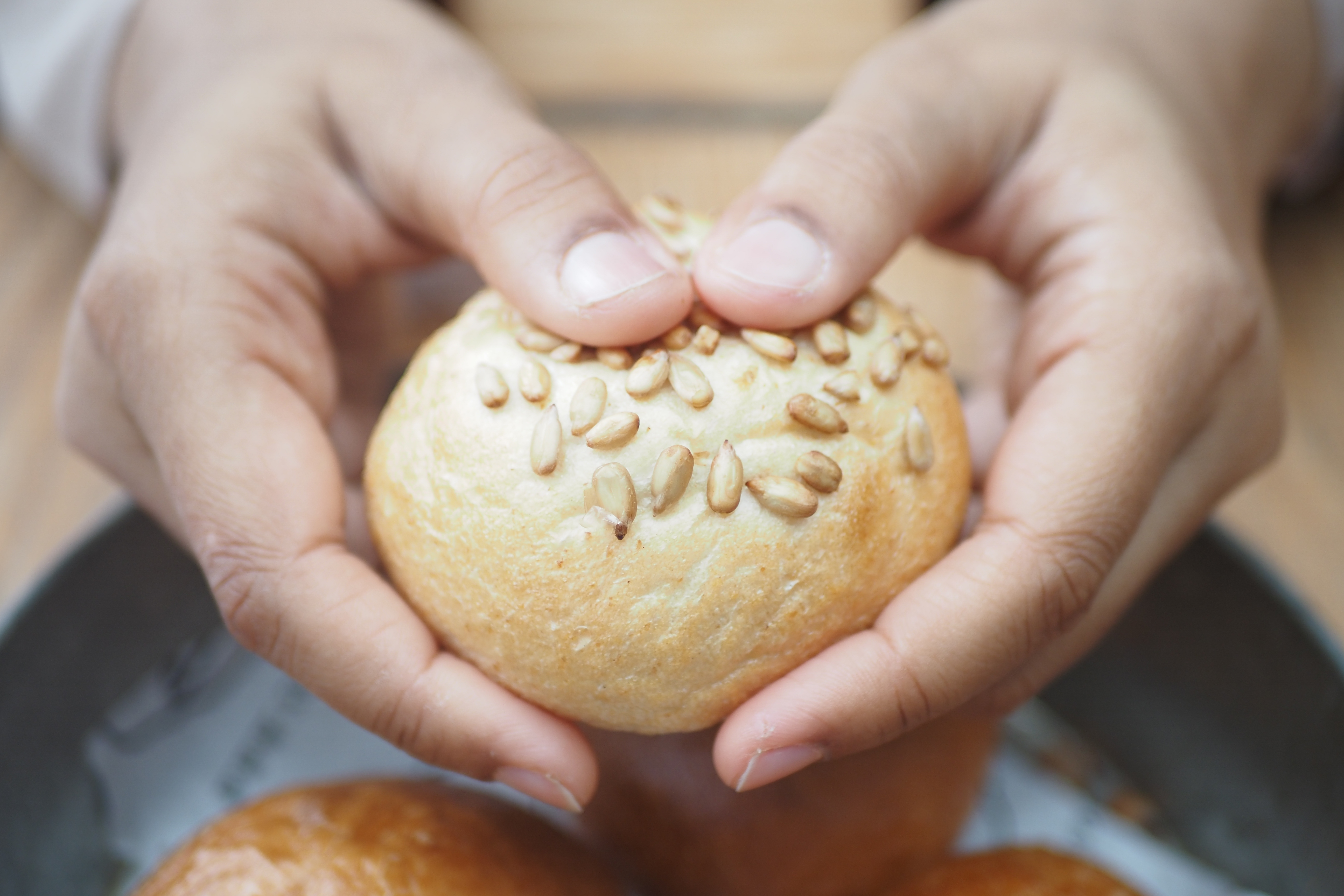 women hand breaking breads closeup 