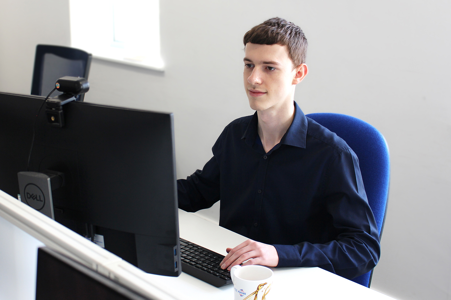technical administration apprentice working on computer in office