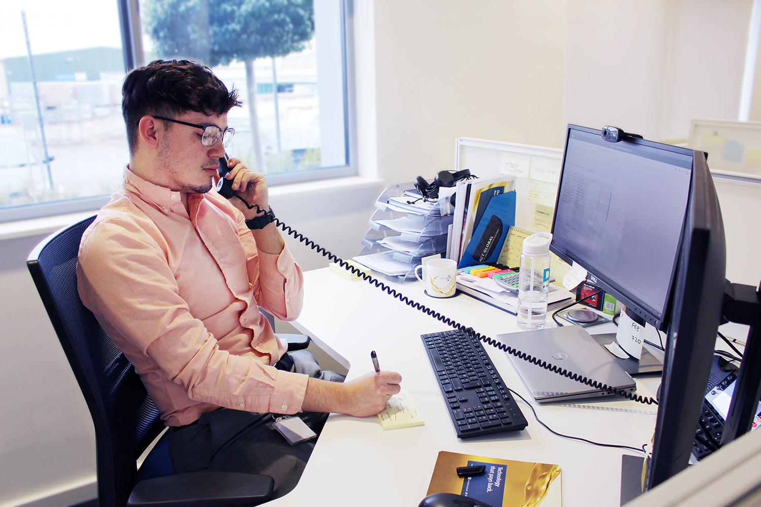 Automotive Sales Apprentice on the phone to a customer in FUCHS UK office