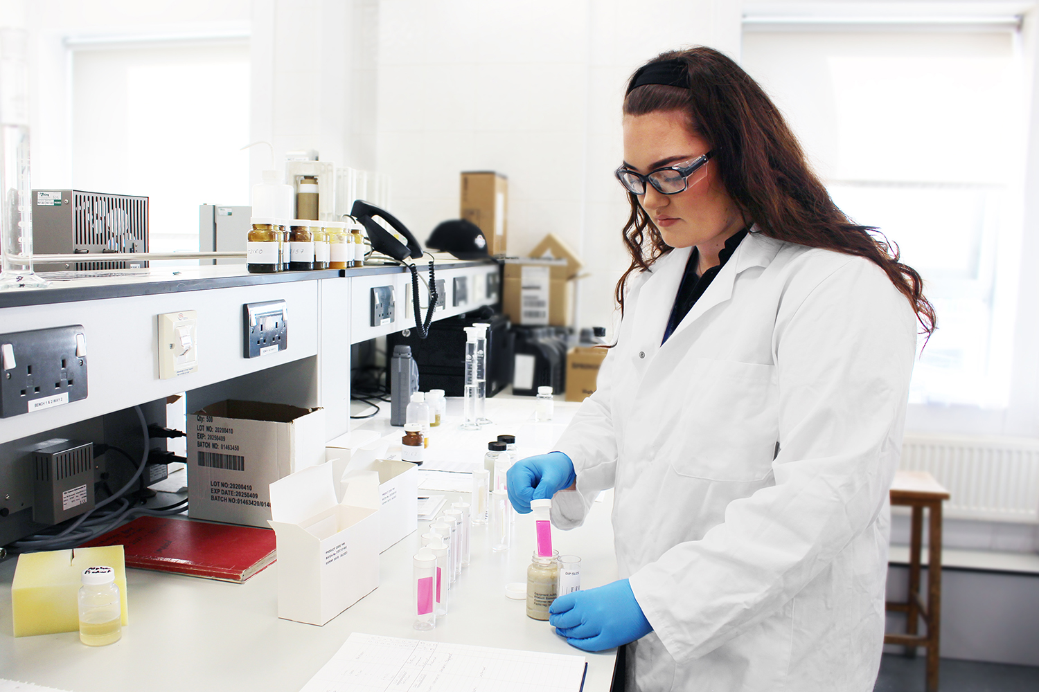 Female apprentice chemist working in FUCHS laboratory